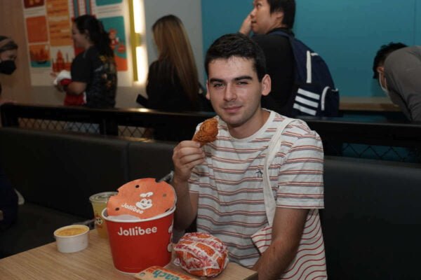 A customer enjoys his Chicken Joy during the opening of Jollibee Times Square.