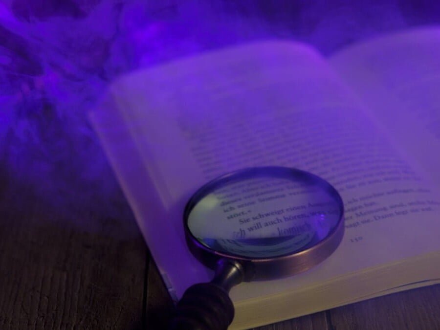 Open book with magnifying class