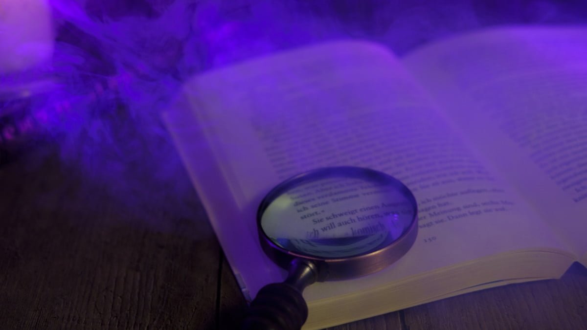 Open book with magnifying class