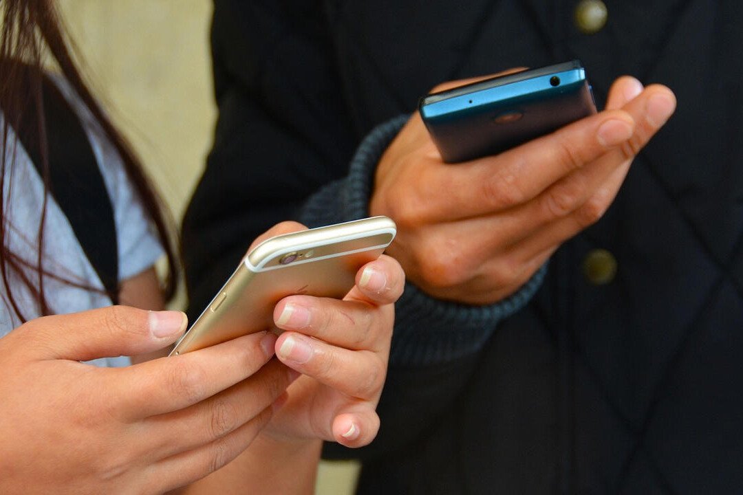 hands holding mobile phones