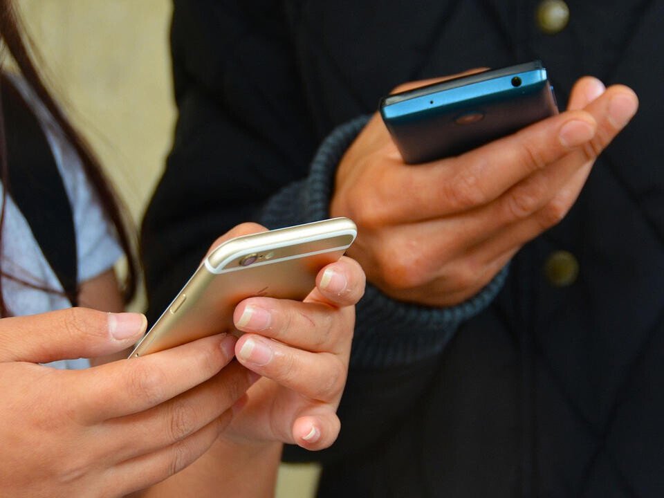 hands holding mobile phones